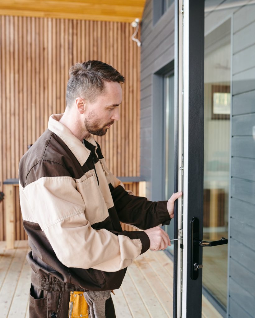 young-repairman-fixing-lock-in-large-transparent-door.jpg